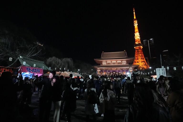 People queue to pray at Zojoji Buddhist temple on New Year's Eve Sunday, Dec. 31, 2023, in Tokyo. (AP Photo/Eugene Hoshiko)