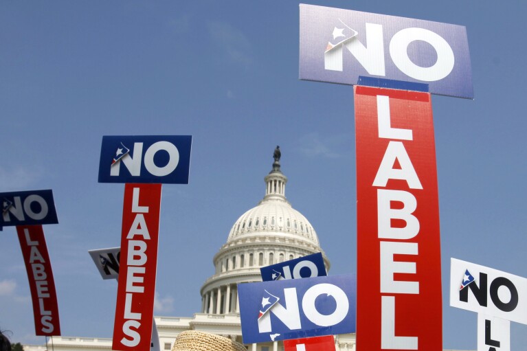 FILE - People with the group No Labels hold signs during a rally on Capitol Hill in Washington, July 13, 2013. The No Labels group says it won't field a presidential candidate in November after strategists for the bipartisan organization were unable to attract a candidate willing to seize on the widespread dissatisfaction with President Joe Biden and Donald Trump. (AP Photo/Jacquelyn Martin, File)