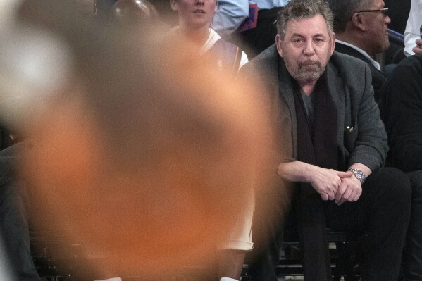 FILE - New York Knicks owner James Dolan, front right, watches the first half of an NBA basketball game March 6, 2020, at Madison Square Garden in New York. The Knicks are suing the Toronto Raptors, and a former Knicks employee Monday, Aug. 21, 2023, saying the worker stole thousands of videos and other scouting secrets to give to his new Canadian employer. (AP Photo/Mary Altaffer, File)