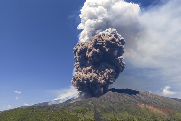 Smoke billows from Mount Etna volcano, Italy, Monday, June 2, 2025. (AP Photo/Giuseppe Distefano)