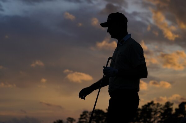 Justin Rose, of England, walks on the 18th green during the third round of the Masters golf tournament on Saturday, April 10, 2021, in Augusta, Ga. (AP Photo/David J. Phillip)