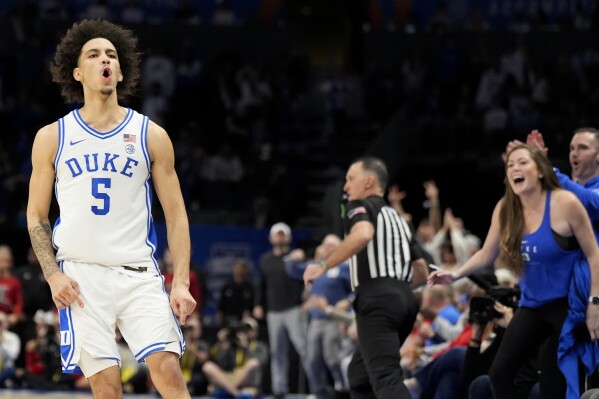 Duke guard Tyrese Proctor celebrates after scoring during the second half of an NCAA college basketball game against Louisville in the championship of the Atlantic Coast Conference tournament, Saturday, March 15, 2025, in Charlotte, N.C. (AP Photo/Chris Carlson)