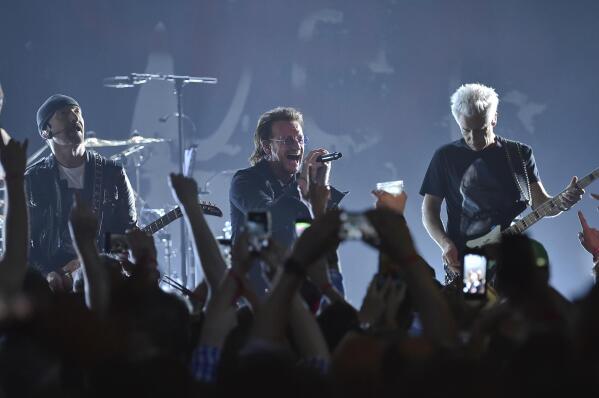 FILE - The Edge, from left, Bono and Adam Clayton of U2 perform during a concert at the Apollo Theater on June 11, 2018, in New York. Live Nation and Sphere Entertainment announced Monday the dates for U2’s upcoming “U2:UV Achtung Baby Live At Sphere” shows starting Sept. 29. The band’s special five-night run of shows will be held until Oct. 8 at The Venetian’s MSG Sphere.(Photo by Evan Agostini/Invision/AP, File)