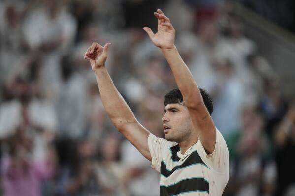 Spain's Carlos Alcaraz celebrates after defeating Bosnia and Herzegovina's Damir Dzumhur during their third-round match of the French Tennis Open at the Roland-Garros stadium in Paris, Friday, May 30, 2025. (AP Photo/Thibault Camus)