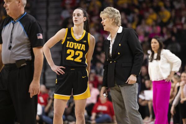 Iowa's Caitlin Clark (22) talks with head coach Lisa Bluder, front right, during the second half of an NCAA college basketball game Sunday, Feb. 11, 2024, in Lincoln, Neb. (AP Photo/Rebecca S. Gratz)