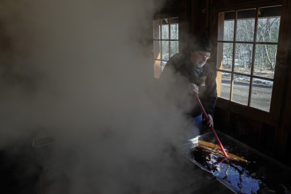 Bob Martin stirs maple syrup, Sunday, Feb. 25, 2024, in Rhinelander, Wis. (AP Photo/Joshua A. Bickel)