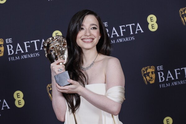 Mikey Madison poses with the leading actress award for 'Anora' at the 78th British Academy Film Awards, BAFTA's, in London, Sunday, Feb. 16, 2025. (Photo by Joel C Ryan/Invision/AP)