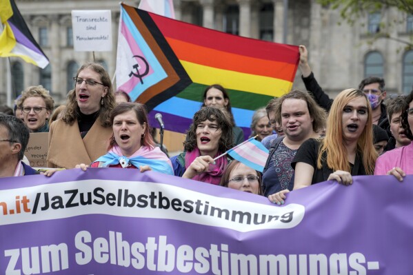 Demonstrators protest demanding a law to protect the rights of the transgender community outside of the parliament Bundestag building in Berlin, Friday, Apri 12, 2024. German lawmakers on Friday approved legislation that will make it easier for transgender, intersex and nonbinary people to change their name and gender in official records. (AP Photo/Ebrahim Noroozi)