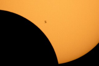 FILE - In this image made available by NASA, the International Space Station is silhouetted against the sun during a solar eclipse Monday, Aug. 21, 2017, as seen from Ross Lake, Northern Cascades National Park in Washington state. Inmates in New York are suing the state corrections department over the decision to lock down prisons during the total solar eclipse, Monday, April 8, 2024. (Bill Ingalls/NASA via AP, File)
