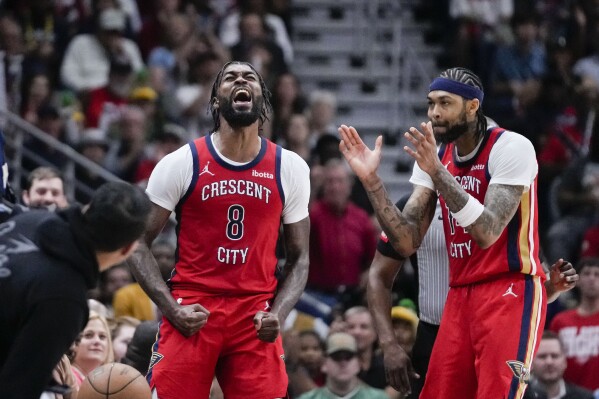 New Orleans Pelicans forward Naji Marshall (8) reacts with forward Brandon Ingram after a turnover in the second half of an NBA basketball play-in tournament game against the Sacramento Kings in New Orleans, Friday, April 19, 2024. The Pelicans won 105-98. (AP Photo/Gerald Herbert)