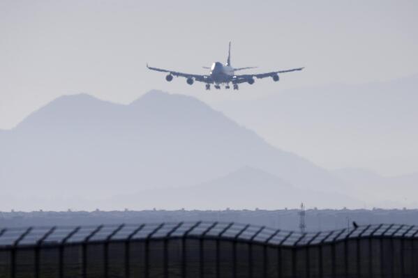 An airplane prepares to land at March Air Reserve Base in Riverside, Calif. Jan. 29, 2020. Congress is looking into just how quickly airline passengers can evacuate a plane during an emergency. Some lawmakers aren't sure modern planes can be evacuated in 90 seconds, as federal rules require. Sen. Tammy Duckworth of Illinois introduced legislation Wednesday, May 31, 2023 to set standards for Federal Aviation Administration tests on how quickly passengers can escape a plane during an emergency. (AP Photo/Ringo H.W. Chiu)