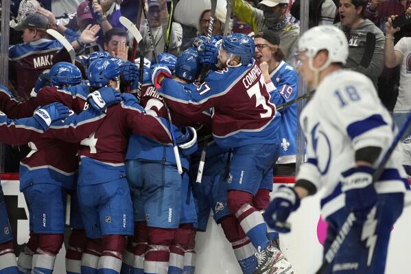 The Colorado Avalanche celebrate after an overtime goal by Andre Burakovsky in Game 1 of the NHL hockey Stanley Cup Final against the Tampa Bay Lightning on Wednesday, June 15, 2022, in Denver. (AP Photo/John Locher )