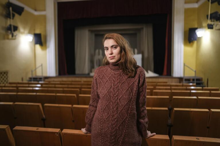 Maria Kutnyakova, an IT specialist, who was nearby the Donetsk Academic Regional Drama Theatre in Mariupol, Ukraine, on March 16, 2022, when it was bombed, poses for a photo at the Lviv Regional Academic Puppet Theater in Lviv, Ukraine, on April 2, 2022. Her mother and sister were inside. (AP Photo/Evgeniy Maloletka)