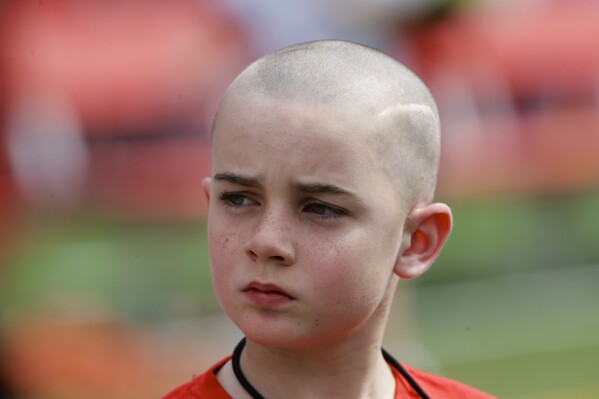 Cancer survivor Jack Hoffman before delivering a drug-free pledge during the halftime of Nebraska's NCAA college football spring game in Lincoln, Neb., April 12, 2014. (AP Photo/Nati Harnik, File)