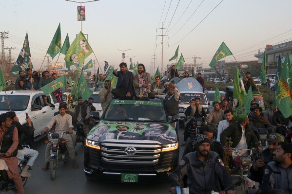 Qari Zahir Shah, center right on vehicle, a winning candidate from Pakistan's former prime minister Nawaz Sharif's party 'Pakistan Muslim League-N, leads rally with his supporters to celebrate his victory in the parliamentary elections, in Peshawar, Pakistan, Sunday, Feb. 11, 2024. (AP Photo/Muhammad Sajjad)