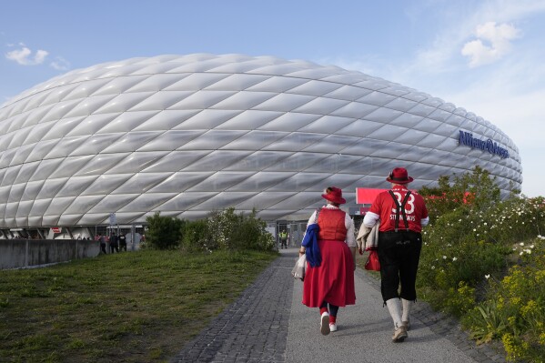 FILE - Bayern Munich fans arrive to the Allianz Arena prior to the Champions League semifinal first leg soccer match between Bayern Munich and Real Madrid at the Allianz Arena in Munich , Germany, Tuesday, April 30, 2024. UEFA has a two-step financial mission to refill its pandemic-hit cash reserves. It starts with a men’s 2024 European Championship held in the home of the continent’s largest economy. (AP Photo/Matthias Schrader, File)