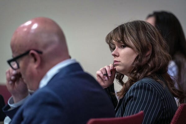 Hannah Gutierrez-Reed, center, sits with her attorney Jason Bowles, left, during testimony in the trial against her in First District Court, in Santa Fe, N.M., Friday, March, 1, 2024. Gutierrez-Reed was working as the armorer on the movie 