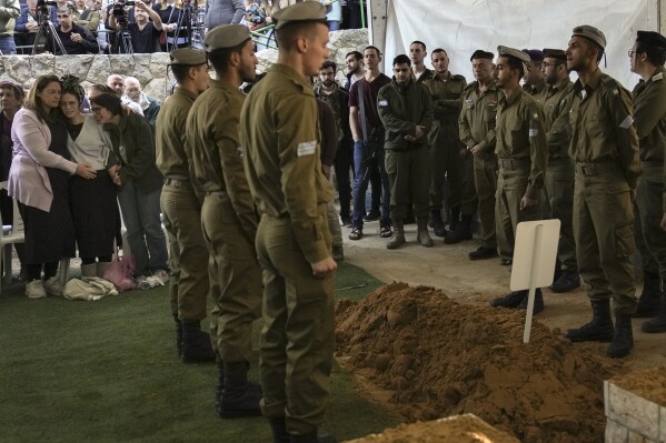 Close relatives, left, of combat engineer squad commander Staff Sgt. Zamir Burke, 20, from Beit Shemesh, mourn during his funeral at Mount Herzl military cemetery in Jerusalem, Israel, Sunday Nov. 1, 2024. Burke was killed in combat with Hamas at the Jabaliya refugee camp in Gaza. (APcPhoto/Mahmoud Illean)