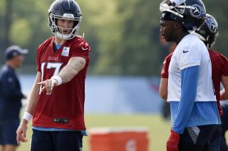 Tennessee Titans quarterback Ryan Tannehill (17) talks with wide receiver Julio Jones (2) during NFL football training camp Thursday, July 29, 2021, in Nashville, Tenn. (AP Photo/Mark Zaleski)