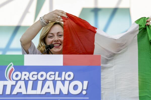 FILE — Giorgia Meloni holds an Italian flag as she addresses a rally in Rome, Saturday, Oct. 19, 2019. As a young teen, Italy's Giorgia Meloni embarked on an ideological quest that has propelled her to the verge of government power. The Sept. 25 election victory of her Brothers of Italy, a party with neo-fascist roots that she helped establish a decade ago, provided Meloni with a springboard into the Italian premiership. (AP Photo/Andrew Medichini)