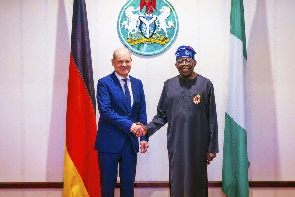 In this photo released by the Nigeria State House, German Chancellor Olaf Scholz, left, is welcomed by Nigeria's President Bola Tinubu, right, upon his arrival at the Presidential palace in Abuja, Nigeria, Sunday, Oct. 29, 2023. The German Chancellor Olaf Scholz met with Nigerian President Bola Tinubu on Sunday as part of a West Africa tour as the European country looks to diversify its trade partners and expand economic partnerships in the energy-rich region. (Nosa Asemota/Nigeria State House via AP)