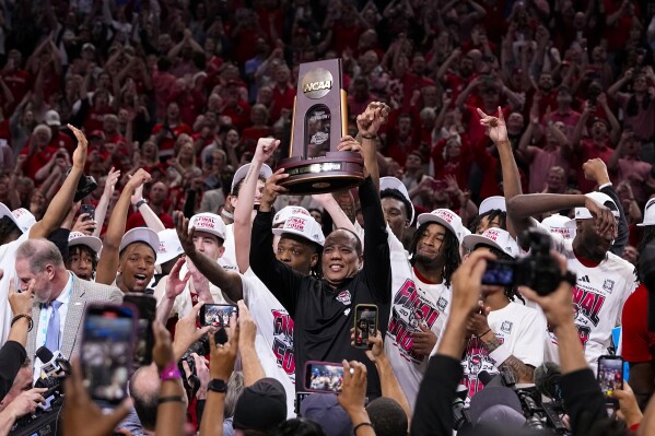 North Carolina State head coach Kevin Keatts holds the South Regional trophy following an Elite Eight college basketball game in the NCAA Tournament against Duke in Dallas, Sunday, March 31, 2024. North Carolina State won 76-64. (AP Photo/Tony Gutierrez)