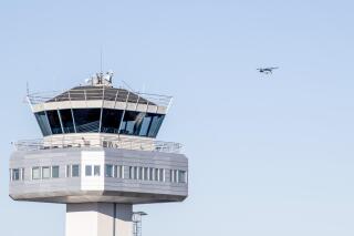 A view of the air traffic control tower at Flesland Airport as a small propeller plane flies in background, in Bergen, Norway, Wednesday, Oct. 19, 2022. Authorities say the airport in Norway’s second-largest city has briefly closed after at least one drone was spotted nearby by area residents. A police spokesman said the first drone sighting at Bergen Airport was reported at 4:15 a.m. on Wednesday. (Marit Hommedal/NTB Scanpix via AP)