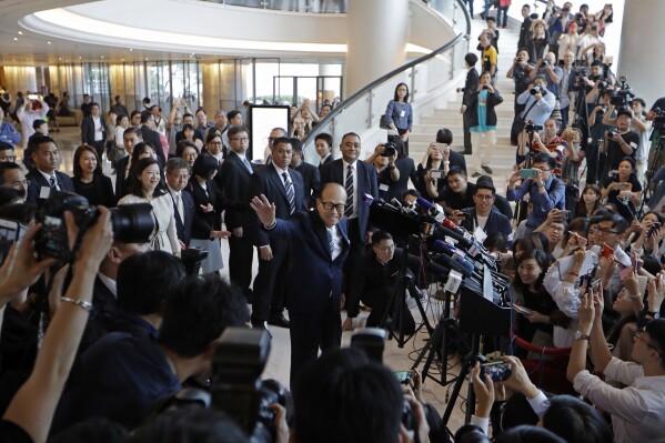 Hong Kong tycoon Li Ka-shing, chairman of CK Hutchison Holdings company, waves goodbye to media after the company's Annual General Meeting in Hong Kong, May 10, 2018. (AP Photo/Kin Cheung, File)