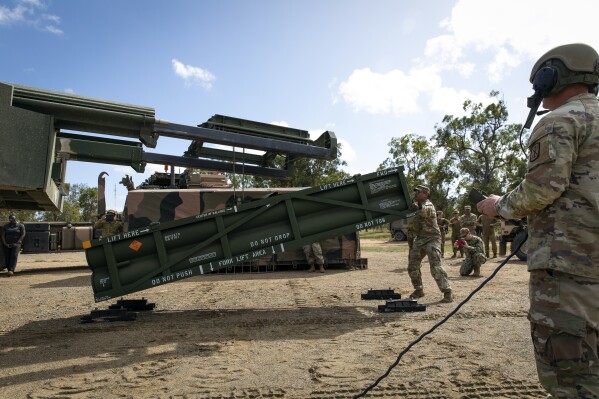 FILE - In this image provided by the U.S. Army, Staff Sgt. Jimmy Lerma, crew chief for Alpha Battery, 1st Battalion, 3rd Field Artillery Regiment, 17th Field Artillery Brigade, adjusts the Army Tactical Missile System (ATACMS) for loading on to the High Mobility Artillery Rocket System (HIMARS) at Williamson Airfield in Queensland, Australia, on July 26, 2023. Ukraine is having some success in halting Russia's new push along the northeast front weeks after the decision allowing the country to use U.S.-supplied weapons for limited strikes in Russian territory. But commanders say their hands are tied without the ability to use long-range guided missiles, such as ATACMS. (Sgt. 1st Class Andrew Dickson/U.S. Army via AP)