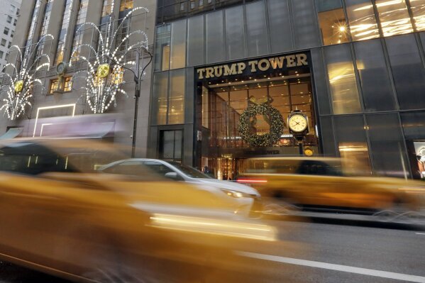 
              FILE - In this Nov. 29, 2016, file photo, morning traffic on Fifth Avenue passes Trump Tower, in New York. For decades, President Donald Trump’s identity was interwoven with his hometown of New York City: big, brash and dedicated to making money. Manhattan was the imposing backdrop as Trump transformed himself from local real-estate developer to celebrity businessman, skyscrapers and gossip pages featured his name, and during last year’s presidential campaign he’d fly thousands of miles to sleep in his own bed at Trump Tower. (AP Photo/Richard Drew, File)
            