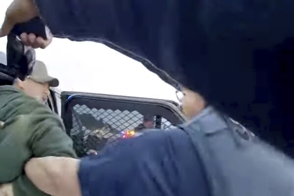 FILE - This still image taken from a Las Animas County deputies body camera and provided by Mehr Law PLLC shows Kenneth Espinoza, who was stunned with a Taser while handcuffed, including in his lip. Espinoza has settled a federal lawsuit with a Colorado sheriff's department for $1.5 million, his lawyers said Monday, March 4, 2024. (Las Animas County Sheriff's Office/Mehr Law PLLC via AP, file)