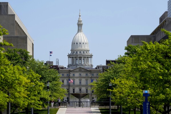 FILE - The Michigan Capitol is seen, May 24, 2023, in Lansing, Mich. Michigan officials are projecting that the state's tax revenue will see a slight decrease from the previous year but then rebound in the next two years. (Ǻ Photo/Carlos Osorio, File)
