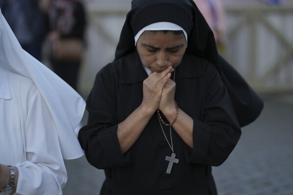Sor Clara a nun from Peru prays during the speech of the newly elected Pope Leo XIV at the Vatican, Thursday, May 8, 2025. (AP Photo/Francisco Seco)