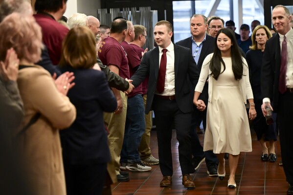 Minnesota State Trooper Ryan Londregan is greeted by supporters as he arrives with his wife, Grace, and his legal team, Monday, April 29, 2024, at the Hennepin County Government Center in Minneapolis. Troopers lined the Hennepin County Government Center atrium as Londregan's attorneys argued that murder charges against him be dismissed. (Aaron Lavinsky/Star Tribune via AP)