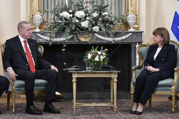 Greece's President Katerina Sakellaropoulou, right, speaks with her Turkish counterpart Recep Tayyip Erdogan during their meeting at the Presidential Palace in Athens, Greece, Thursday, Dec. 7, 2023. Erdogan arrived in Greece on a visit designed to set the historically uneasy neighbors on a more constructive path and help repair strained his country's strained relationship with the European Union. (AP Photo/Michael Varaklas)
