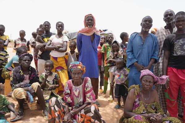 FILE - Internally displaced people wait for aid in Djibo, Burkina Faso, on May 26, 2022. More than 25,000 people will face starvation in conflict-plagued parts of West Africa next year, a United Nations official warned Friday, Dec. 16, 2022. Populations in Nigeria, Mali and Burkina Faso will be in phase five catastrophic hunger by June driven largely by violence as well as economic impacts from the fallout of COVID-19 and the war in Ukraine, said the United Nations Friday.(AP Photo/Sam Mednick)