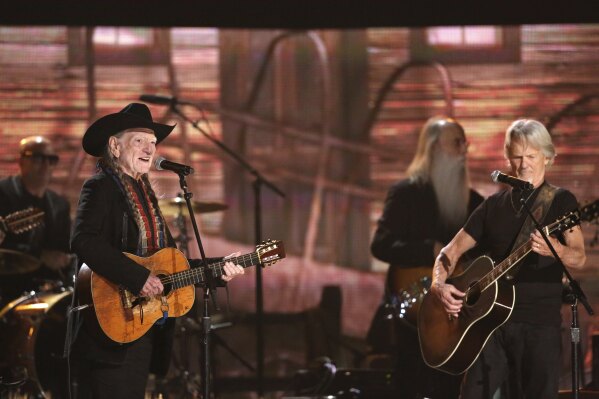 Willie Nelson, left, and Kris Kristofferson perform on stage at the 56th annual Grammy Awards on Jan. 26, 2014, in Los Angeles. (Photo by Matt Sayles/Invision/AP, File)