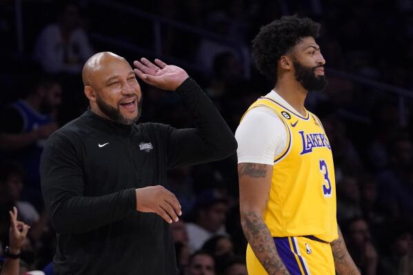 Los Angeles Lakers head coach Darvin Ham, left, talks with forward Anthony Davis during the first half of a preseason NBA basketball game against the Sacramento Kings Monday, Oct. 3, 2022, in Los Angeles. (AP Photo/Mark J. Terrill)