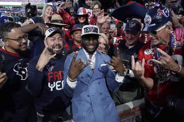 Alabama linebacker Will Anderson Jr. celebrates with fans after being chosen by the Houston Texans with the third overall pick during the first round of the NFL football draft, Thursday, April 27, 2023, in Kansas City, Mo. (AP Photo/Charlie Riedel)