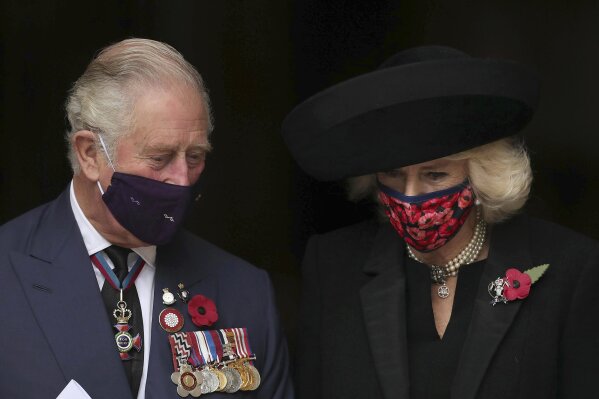 Britain's Prince Charles and Camilla Duchess of Cornwall leave after attending the Armistice Day service at Westminster Abbey in London, Wednesday, Nov. 11, 2020.  The specially arranged service, with social distancing because of the coronavirus, commemorates the 102nd anniversary of the armistice ending World War I, and one hundred years since the symbolic interment of the Unknown Warrior at Westminster Abbey. (Aaron Chown/Pool via AP)