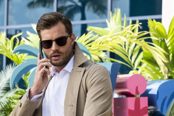 This image released by Lionsgate shows Jamie Dornan in "Barb and Star Go to Vista Del Mar." (Cate Cameron/Lionsgate via AP)