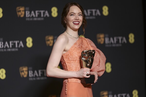 Emma Stone, winner of the leading actress award for 'Poor Things', poses for photographers at the 77th British Academy Film Awards, BAFTA's, in London, Sunday, Feb. 18, 2024. (Photo by Vianney Le Caer/Invision/AP)