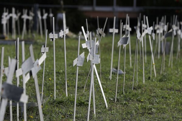 Crosses bearing tags with names are seen in a graveyard of the Flaminio Cemetery, in Rome, Friday, Oct. 16, 2020. Italian prosecutors and the government’s privacy watchdog are investigating how the names of women who miscarried or had abortions ended up on crosses over graves for the fetuses in a Rome cemetery. (AP Photo/Gregorio Borgia)
