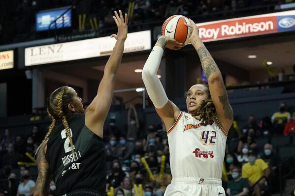 FILE - Phoenix Mercury's Brittney Griner (42) shoots over Seattle Storm's Mercedes Russell in the first half of the second round of the WNBA basketball playoffs Sunday, Sept. 26, 2021, in Everett, Wash. Griner, who was a free agent, re-signed with the Mercury on a one-year contract according to a person familiar with the deal. The person spoke to The Associated Press on condition of anonymity on Saturday, Feb. 18, 2023, because no announcement has been made.(AP Photo/Elaine Thompson, File)
