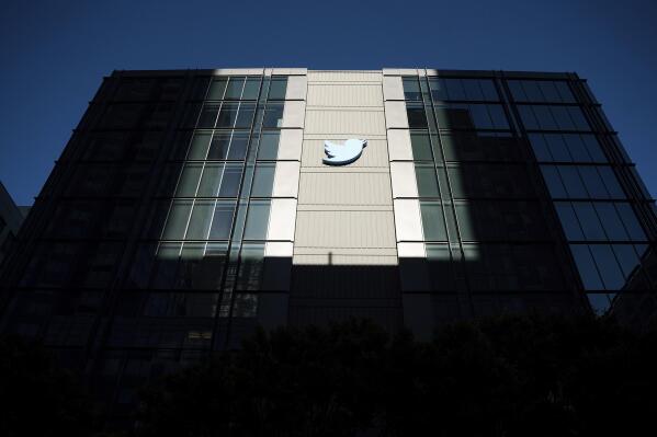 FILE - A Twitter logo hangs outside the company's San Francisco offices on Tuesday, Nov. 1, 2022. Reacting to the tumult and mass layoffs at Twitter under its new owner Elon Musk, a group of Democratic senators on Thursday, Nov. 17, 2022, asked federal regulators to investigate any possible violations by the platform of consumer-protection laws or of its data-security commitments. (AP Photo/Noah Berger, File)