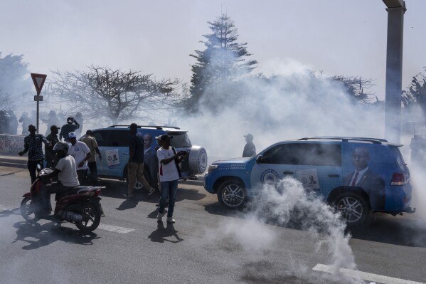 Senegalese riot police lobs tear gas at supporters of opposition presidential candidate Daouda Ndiaye in Dakar, Senegal, Sunday, Feb. 4, 2024. West Africa's regional bloc on Sunday called for dialogue to resolve the political crisis in Senegal as opposition leaders rejected the decision by the country's leader to postpone the Feb. 25 presidential election over an electoral dispute between parliament and the judiciary. (AP Photo/Stefan Kleinowitz)