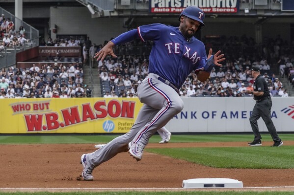 Marcus Semien of the Texas Rangers throws to first base in the