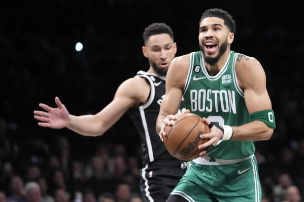 Boston Celtics forward Jayson Tatum, right, goes to the basket past Brooklyn Nets guard Ben Simmons during the first half of an NBA basketball game, Thursday, Jan. 12, 2023, in New York. (AP Photo/Mary Altaffer)