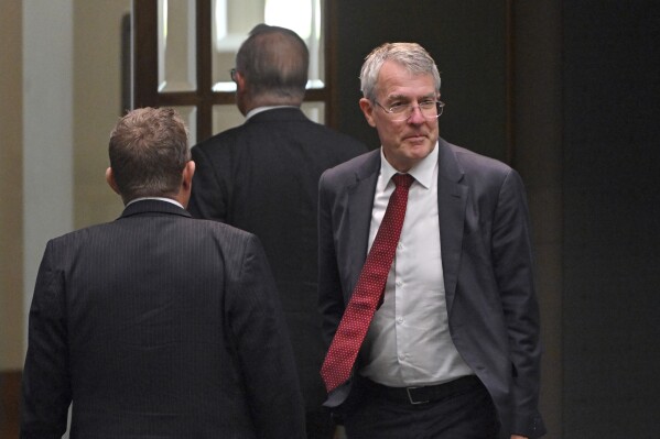 Australia's Attorney-General Mark Dreyfus leaves the house of representatives at Parliament House in Canberra, Tuesday, Feb. 13, 2024. The Australian government said on Tuesday it will outlaw doxxing – the malicious release online of personal or identifying information without the subject’s permission – after pro-Palestinian activists published personal details of hundreds of Jewish people in Australia.(Mick Tsikas/AAP Image via AP)