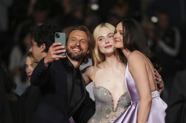 Anders Danielsen Lie, from left, Elle Fanning and Renate Reinsve pose for photographers upon departure from the premiere of the film 'Sentimental Value' at the 78th international film festival, Cannes, southern France, Wednesday, May 21, 2025. (Photo by Scott A Garfitt/Invision/AP)